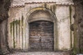 Ancient wooden door in old stone castle wall Royalty Free Stock Photo