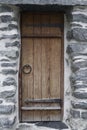 Ancient wooden door in old stone castle wall . Vertical shot Royalty Free Stock Photo