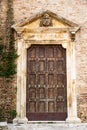 Ancient wooden door of the side entrance of the Cathedral San Massimo di Penne Italy