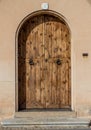 Ancient wooden door in stone castle wall Royalty Free Stock Photo