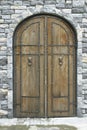 Ancient wooden door in stone castle wall Royalty Free Stock Photo