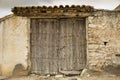 Ancient wooden door on a stone made wall Royalty Free Stock Photo