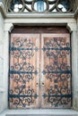 Ancient wooden doors of Church of Sts. Olha and Elizabeth in Lviv, Ukraine. Old medieval wood doorway, soft selective focus Royalty Free Stock Photo