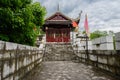 Ancient wooden gatehouse of stone fort in cloudy spring after ra