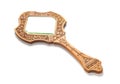 Ancient wooden hand mirror lies on a white background