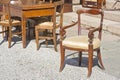 Ancient wooden padded chair just restored with floral decorations at a flea market Royalty Free Stock Photo