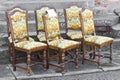 Ancient wooden padded chair just restored with floral decorations at a flea market Royalty Free Stock Photo