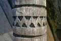 An ancient wooden pillar with a carved pattern. Royalty Free Stock Photo