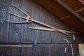 Ancient wooden pitchfork and sickles on old barn