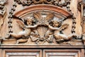 Ancient wooden portal with angels detail in Italy