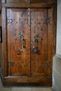 Ancient wooden sacristy door with skull and snake on door mounting, Saint Michael Church Schwabisch Hall, Germany Royalty Free Stock Photo