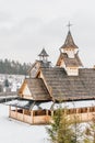 Ancient wooden Slavic church on a snowy landscape. Historical and Architectural Museum in the open air. Kiev, Ukraine.