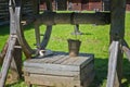 Ancient wooden water well and the cat