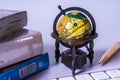 An ancient world globe, books, pen and keyboard Royalty Free Stock Photo