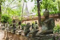 Ancient Wreckage Buddha Statue with Great Stupa Background at Wat U Mong Temple, Chiangmai, Thailand