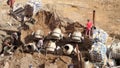 Ancillary workers serving concrete mixers and loading concrete on a large construction sit