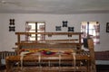 The ancinet weaving loom in an enterior of a wooden log hut