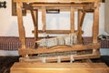 The ancinet weaving loom in an enterior of a wooden log hut