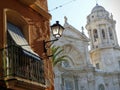 Andalusian balcony with a white cathedral behind to Cadiz in Spain.