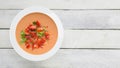 Andalusian gazpacho served in a white plate on a wooden table. Top view and empty copy space Royalty Free Stock Photo