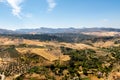 Andalusian landscape view of fields and Spanish vineyards near Ronda, Spain, during sunny summer day, mountains in the background Royalty Free Stock Photo