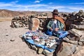 An Andean lady sells items to tourists on a remote road in the Uyuni region of Bolivia