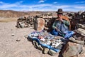 Andean lady sells items to tourists on a remote road in the Uyuni region of Bolivia
