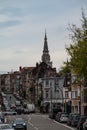 Anderlecht, Brussels Capital Region, Belgium - Regular street with residential houses and the tower of the Saint Guy church
