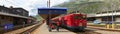 ANDERMATT, SWITZERLAND, AUG, 20, 2010: Panoramic view on Swiss Alpine railway station red mountain electric passenger train Royalty Free Stock Photo