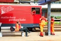 ANDERMATT, SWITZERLAND, AUG, 20, 2010: Train drivers in on Swiss Alpine rail way station. Red mountain electric passenger train Royalty Free Stock Photo