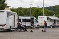 Andernach, Rhineland-Palatinate, Germany - August 9,2021: tourists sitting and standing in front of their camp vans