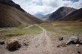 Andes Mountains landscape with hiking trail. View to Aconcagua Peak in clouds. Aconcagua provincial park, Mendoza province, Royalty Free Stock Photo