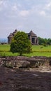 Andesite stone former paseban room in Ratu Boko temple with background, trees and gate