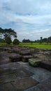 Andesite stone former paseban room in Ratu Boko temple with background, trees and gate