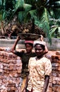 Andhra Pradesh, India, circa August 2002: Female workers carry bricks