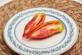 Andine Cornue tomato over a vintage plate Royalty Free Stock Photo