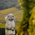 Andlau, Alsace village, vineyard, statue of monk carrying wine barrel Royalty Free Stock Photo