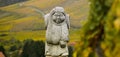 Andlau, Alsace village, vineyard, statue of monk carrying wine barrel Royalty Free Stock Photo