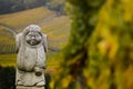 Andlau, Alsace village, vineyard, statue of monk carrying wine barrel Royalty Free Stock Photo