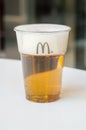 Mahou beer in a plastic cup in McDonald restaurant