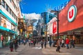 People duty free shopping, street with modern shops in Andorra