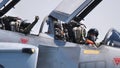 Close up of military pilots in the opened cockpits of a fighter jet plane