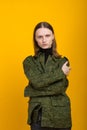 Androgen. Androgynous character on a yellow background. Man or woman. Military style