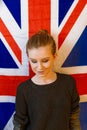 Androgyne girl looking dawn in front of Union Jack Flag