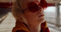 Androgyne woman with red sunglasses