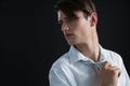 Androgynous man adjusting his tie Royalty Free Stock Photo