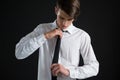 Androgynous man adjusting his tie Royalty Free Stock Photo