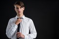 Androgynous man adjusting his tie Royalty Free Stock Photo