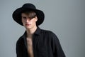 Androgynous man in hat posing