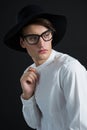 Androgynous man in hat posing with hand on collar Royalty Free Stock Photo